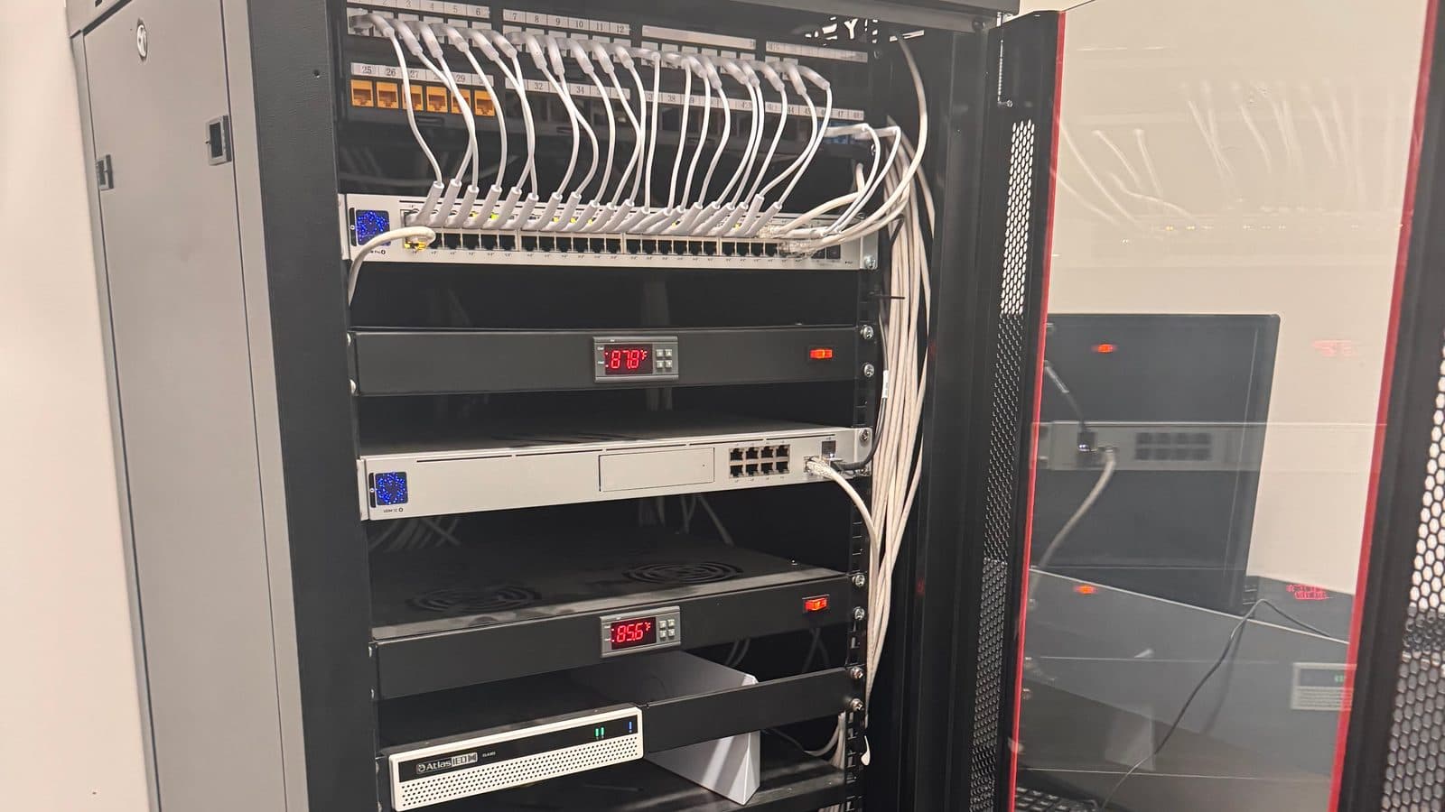 Dressed patch panel and UniFi switch in a wall-mount network rack