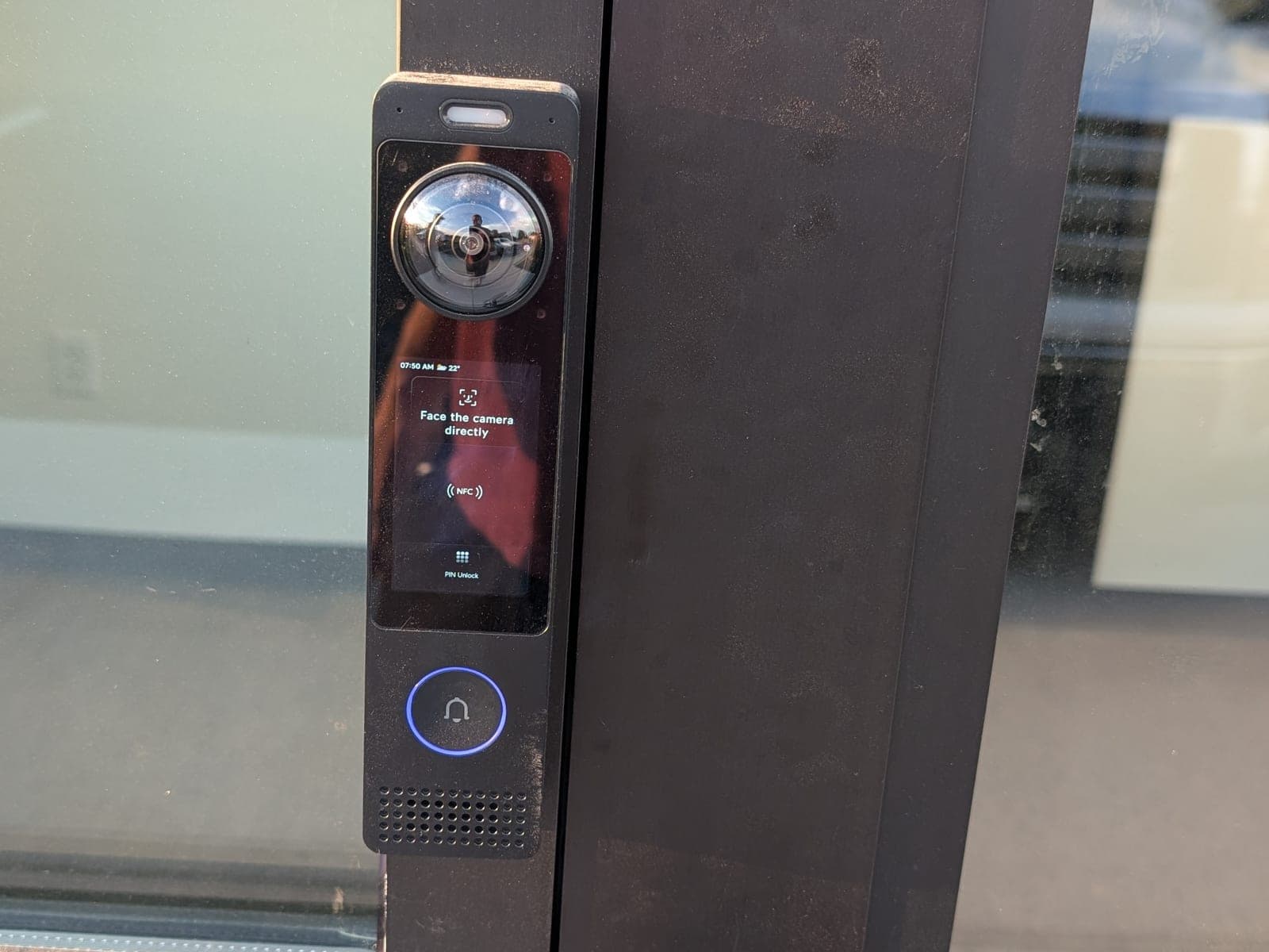 UniFi Access reader on a glass storefront door frame showing the face-recognition prompt
